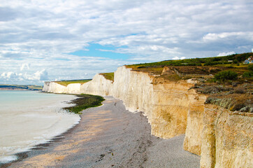 Seven sisters cliffs on the cloudy day in summer. Chalk cliffs landscape.