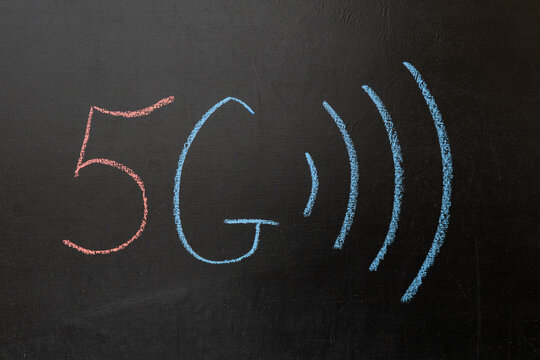 Concept of 5G technology on a chalkboard. Drawing of radio waves