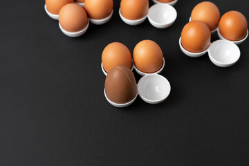 some raw chicken eggs in the tray with the ch, creative minimal conceptocolate egg