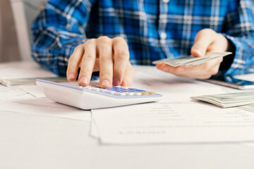 counting cash money, person calculate personal earnings and savings at the table