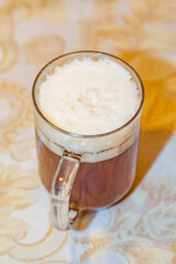 Glass mug with fresh brown beer
