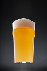 Glass of beer on black background, copy space