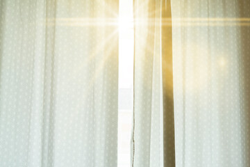 the window with curtains and a sun beam go through, wake up, early morning time