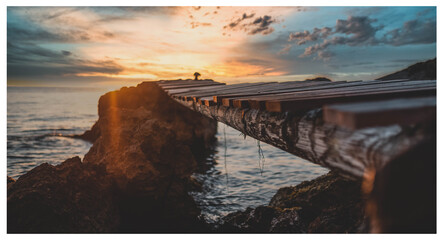 sunset over the ocean over the bridge