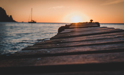 Wood bridge in the beach and sunset