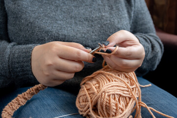 Women's hands knit from color wool. Hand knitting