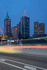 Melbourne CBD with with light trails in the foreground.