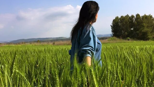 young nice woman on green fild. High quality 4k footage.