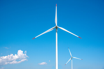 Wind farm on the background of blue sky.