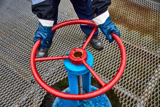 Technician,Hand of technician during open or close manual ball valve for control process in oil and gas flatform offshore