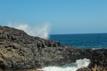 waves hitting the rock