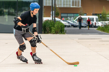 Outdoor sport, ice hockey player off ice practice on rollerskates
