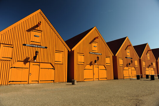 Bright yellow sea historic buildings in Stavern, Vestfold, Norway. Horizontal photo with copy space in lower part.  Blue sky.