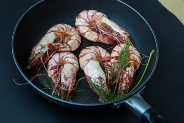 Grilled sea shrimp on black plate