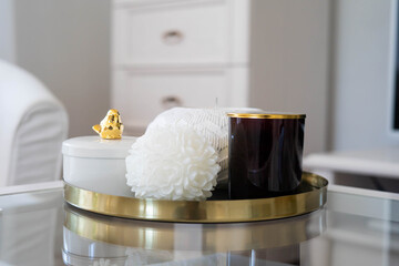 Trendy home deccoration - 
candles on a golden tray staying on the table