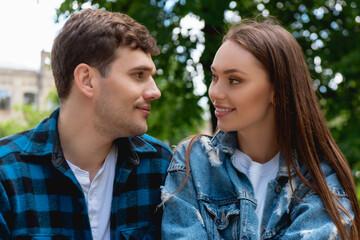 Obraz premium beautiful girl and handsome student smiling while looking at each other