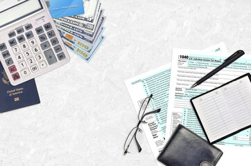 IRS form 1040 Individual income tax return lies on flat lay office table and ready to fill. U.S....