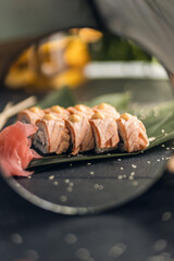 sushi rolls with rice and fish, soy sauce on a dark stone background concept of sushi restaurant summer mood 