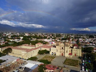 aerial view of Oaxaca with front view of Santo Domingo de Guzman church with thunderstorm clouds and rainbow