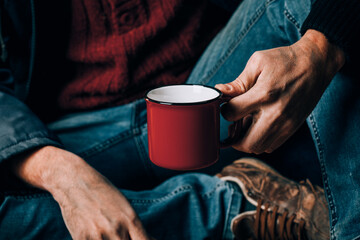 A man begs. He is holding a white paper Cup. The concept of homelessness and poverty.