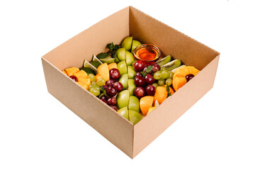 Collection of take away kraft boxes with different food. Set of containers with everyday fruits - grape,apple,kiwi,orange,jelly on white background, 