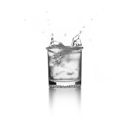 water splash on glass with ice cube on white background