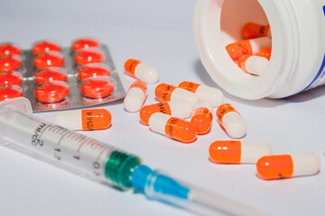 Tablets. Orange capsules. Syringe.