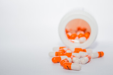 pills in a bottle. Tablets. Orange capsules.