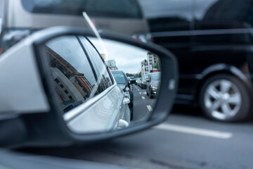 Rearview mirror of a car and reflected traffic
