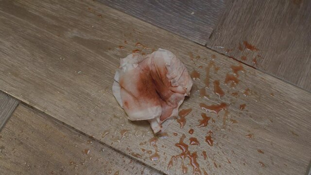 close up shoot of used sanitary pad lying on the floor in the bathroom