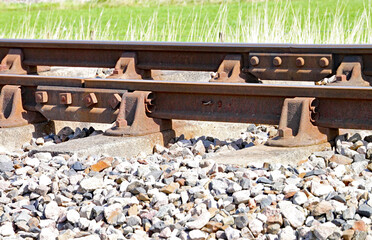 Close up of rusty railway track showing the nuts and bolts of the fishplate which joins sections of...