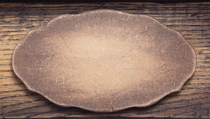 aged wooden nameplate at wood board background