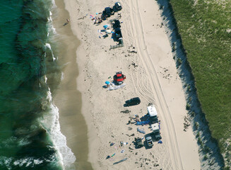Aerial of off road vehicles on beach with ocean waves at Orleans, Cape Cod, Massachusetts.
