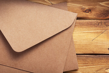 old cardboard postal envelope at wooden background