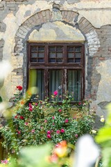 old house window with rose flowers