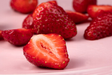 Strawberries on a pink background. Red sweet berries.
