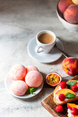 Japanese ice cream Mochi with peach, in rice dough. Traditional Japanese dessert on white background.