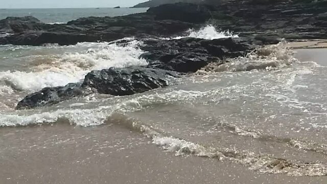 Slowmotion shot of the waves hitting the rocks at 720p