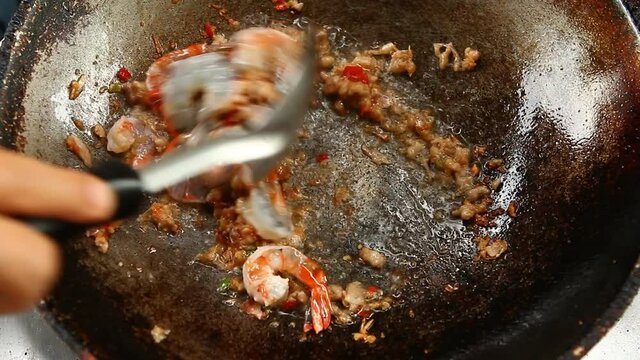 Frying shrimp  with chili paste in pan , in door  Chiangmai Thailand
