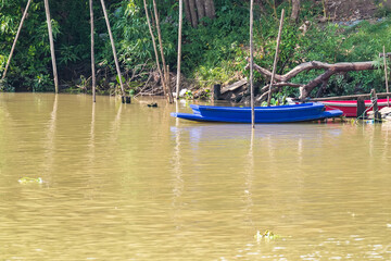 Small boats at shore of parana chao phraya river in Thailand.