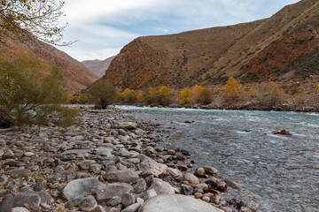 Fototapeta premium The rocky shore of a mountain river. Kokemeren river, mountain river in the Naryn region of Kyrgyzstan.