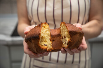 Baked homemade cupcake in the hands of a woman