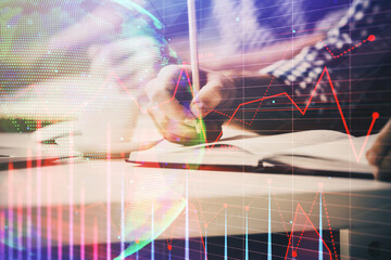 Multi exposure of two men planing investment with stock market forex chart.