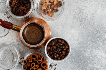 Close up of copper coffee turk on light textured surface