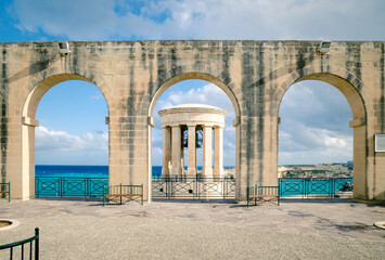 Arch in Upper Barrakka Gardens. Siege bell monument, World War II Memorial, Valletta, Malta. Historic famous landmark