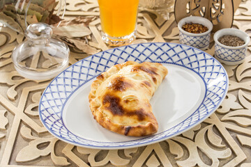 Fresh baked cheese patty bread on oriental wooden table