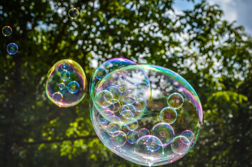Soap bubble with smaller bubbles inside close up