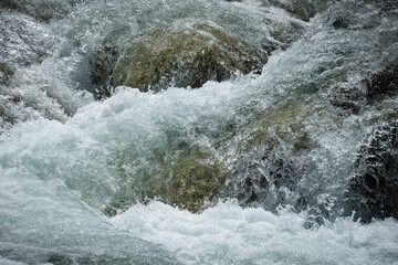 Running mountain river. Abstract shapes made of water.