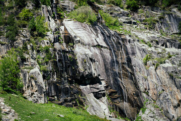 Alpine mountains, meadows, forest and waterfall