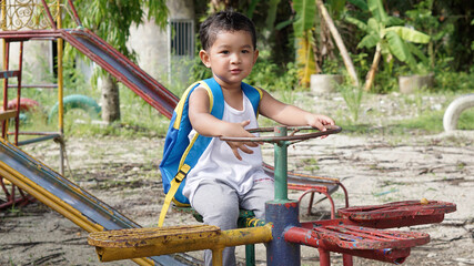Cute Asian boy 2 year old on the way trip out door concept.